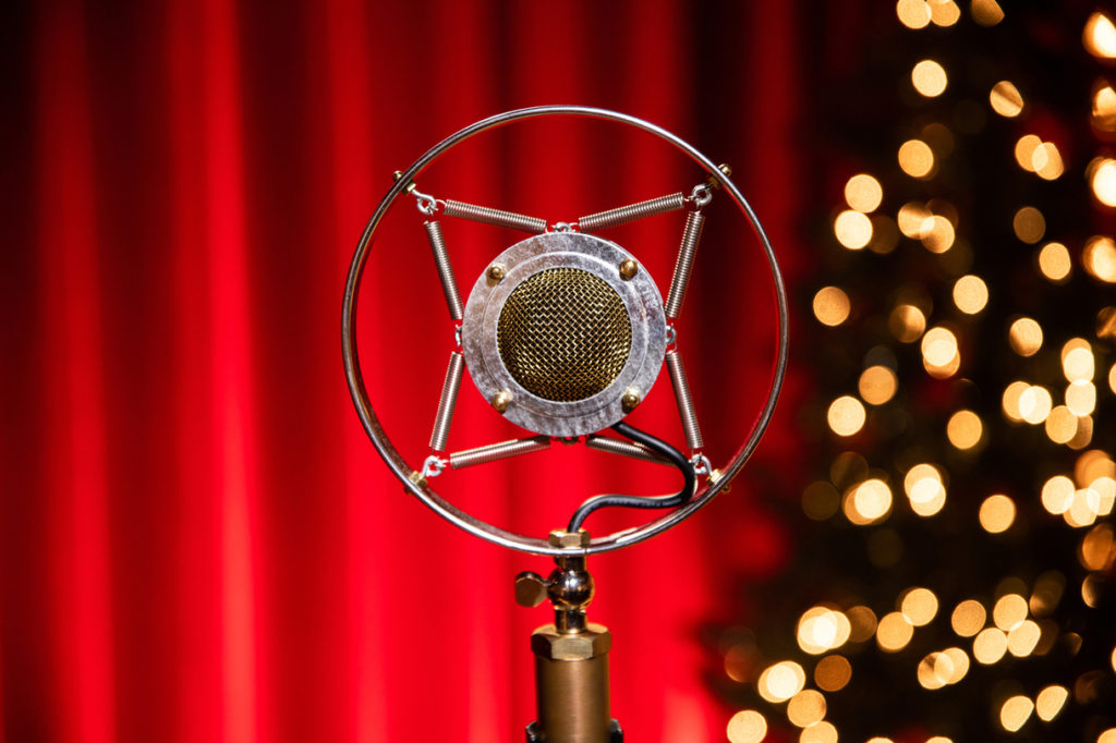 Microphone in front of a Christmas Tree